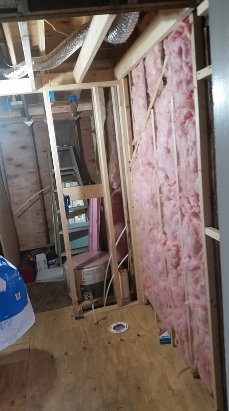 Installing insulation in bathroom build